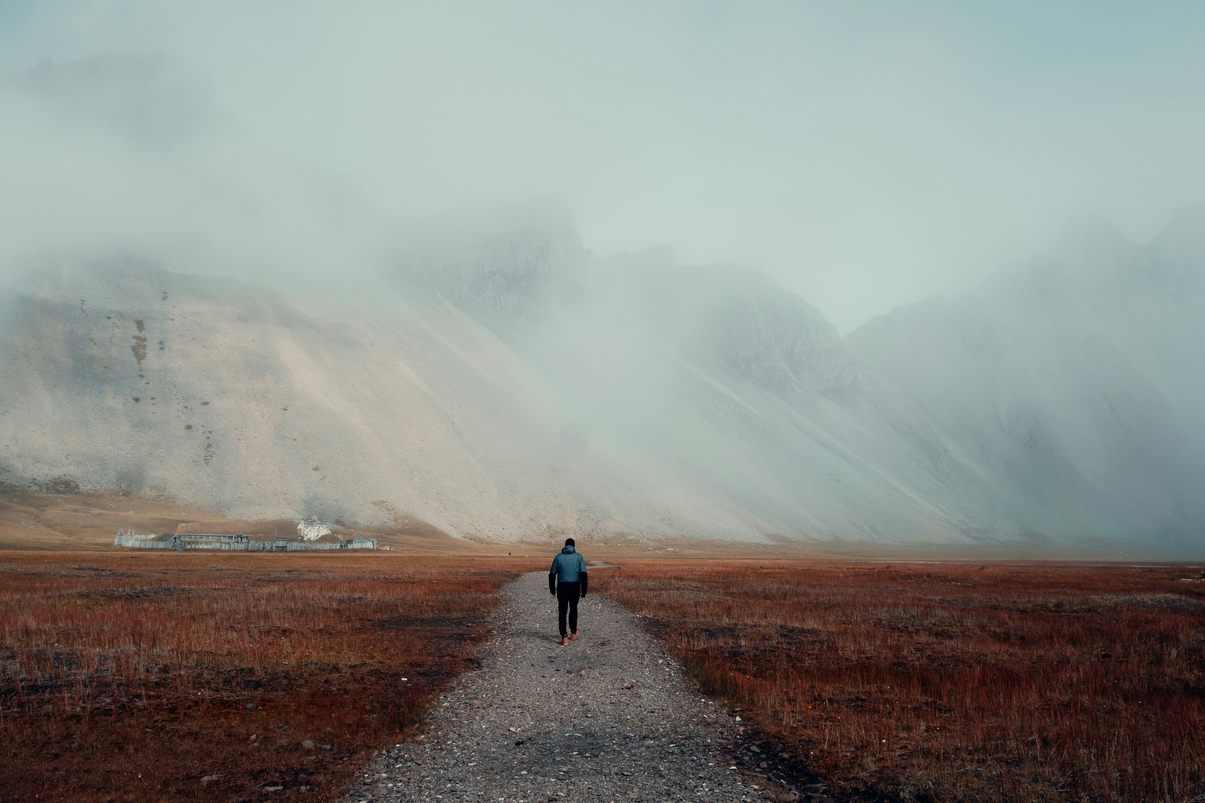 A solitary figure walking along a quiet path, bathed in warm light